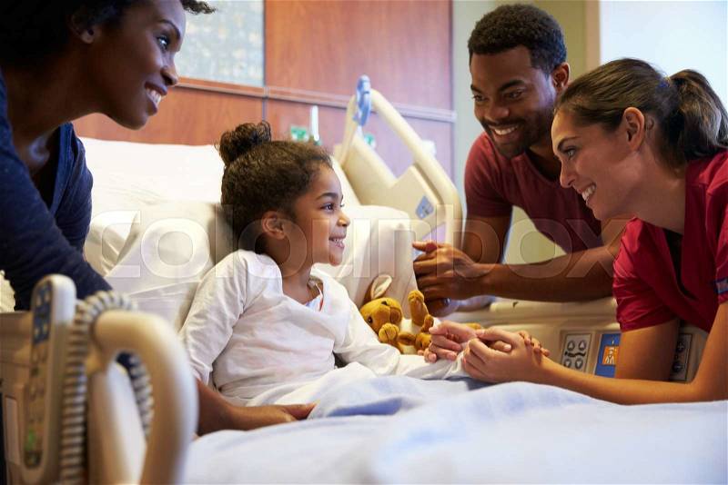 Pediatrician Visiting Parents And Child In Hospital Bed, stock photo