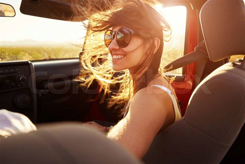 Woman Passenger On Road Trip In Convertible Car, stock photo