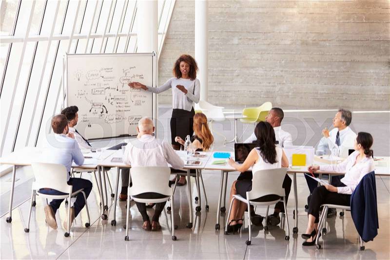 African American Businesswoman Leads Boardroom Meeting, stock photo