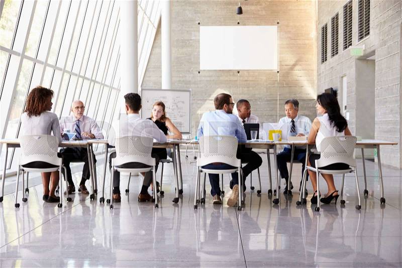 Group Business Meeting Around Table In Modern Office, stock photo