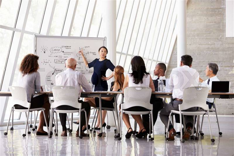 Pregnant Businesswoman Leads Boardroom Meeting, stock photo