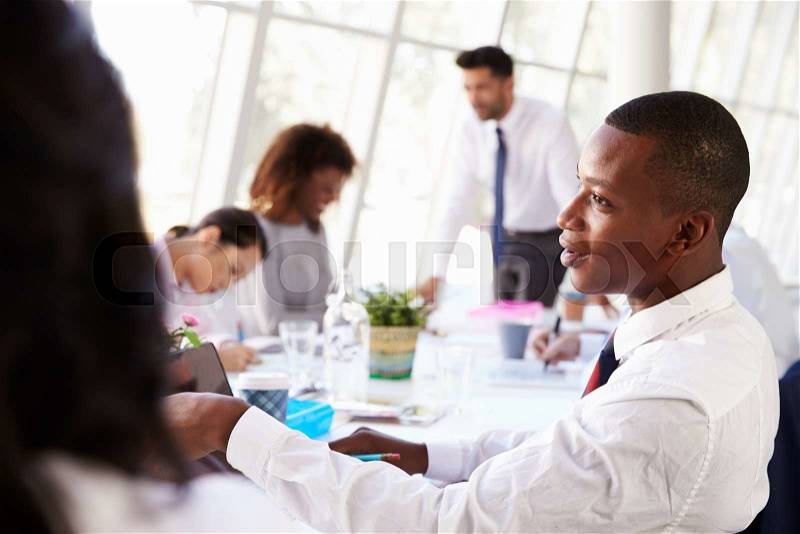 African American Businessman At Meeting With Colleagues, stock photo
