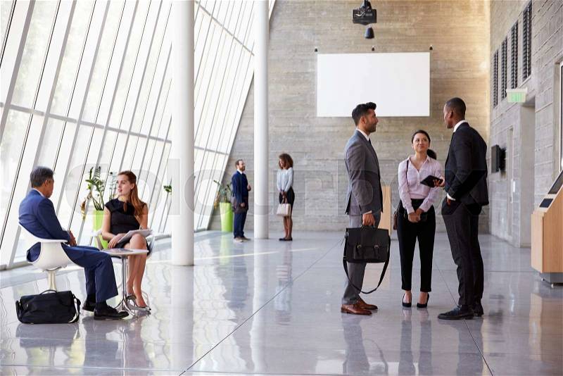 Interior Of Busy Office Foyer Area With Businesspeople, stock photo
