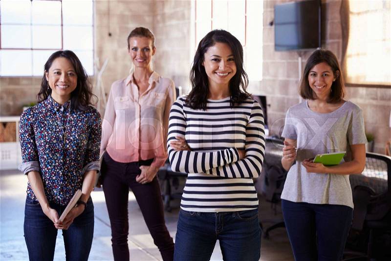 Portrait Of Female Staff Standing In Modern Design Office, stock photo