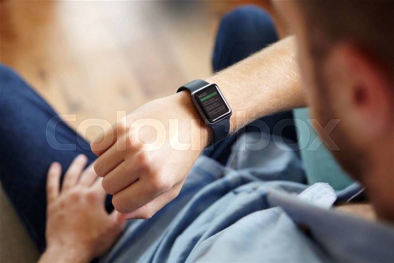 Man Looking At News Application Software On Smart Watch, stock photo