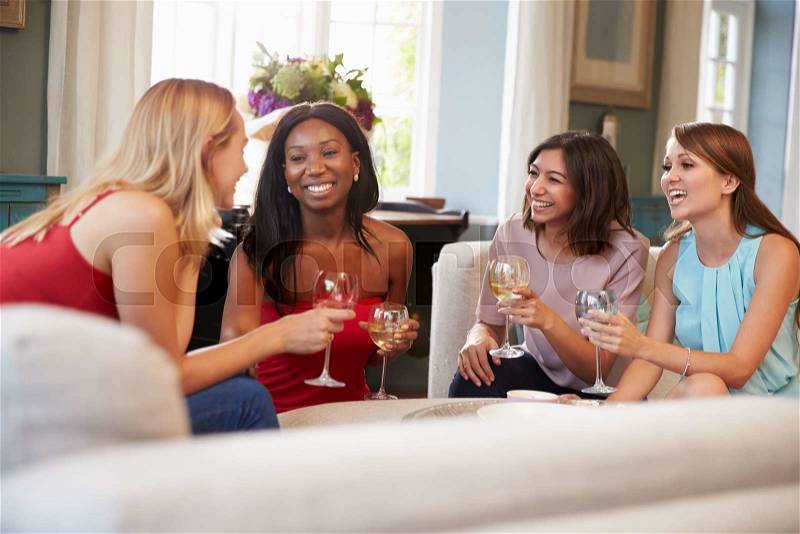 Group Of Female Friends Relaxing At Home With Drinks, stock photo