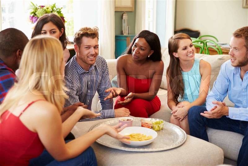 Group Of Friends Relaxing At Home On Sofa Together, stock photo