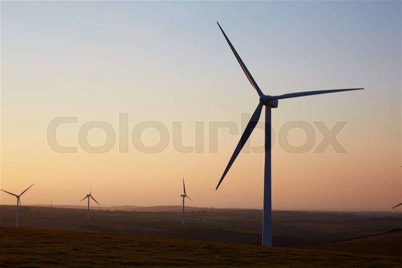 Group Of Wind Turbines In Field At Dusk, stock photo