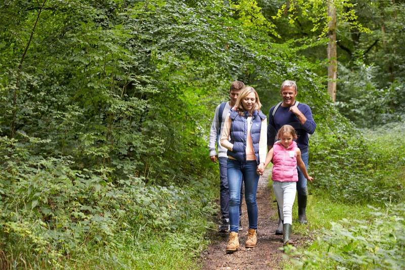 Family On Walk Through Beautiful Countryside, stock photo