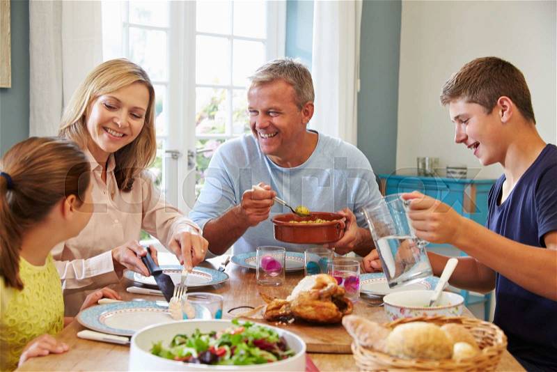 Family Enjoying Meal At Home Together, stock photo