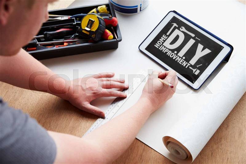 Man Plans Design Project Using Application On Digital Tablet, stock photo