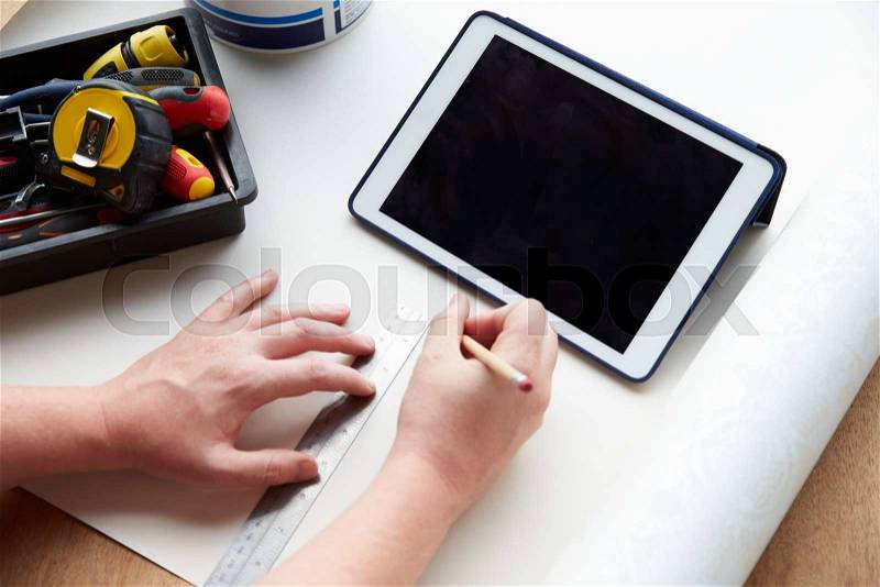 Man Plans Design Project Using Application On Digital Tablet, stock photo
