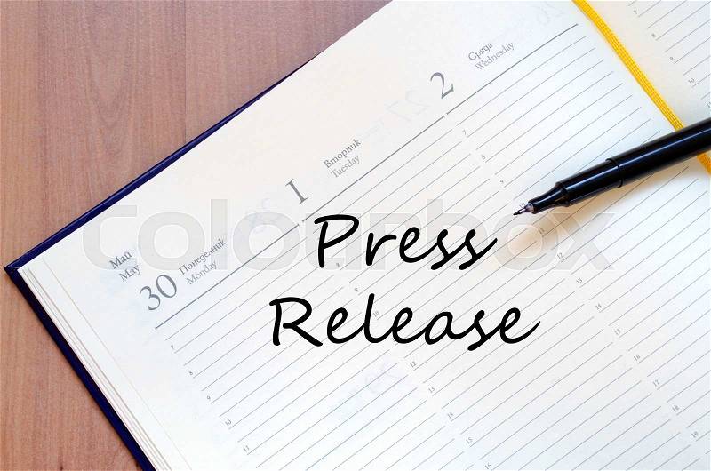 Press release text concept write on notebook with pen, stock photo