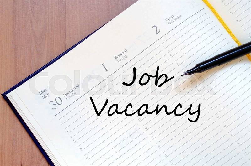 Job vacancy text concept write on notebook with pen, stock photo