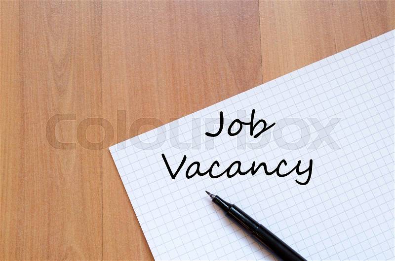 Job vacancy text concept write on notebook with pen, stock photo