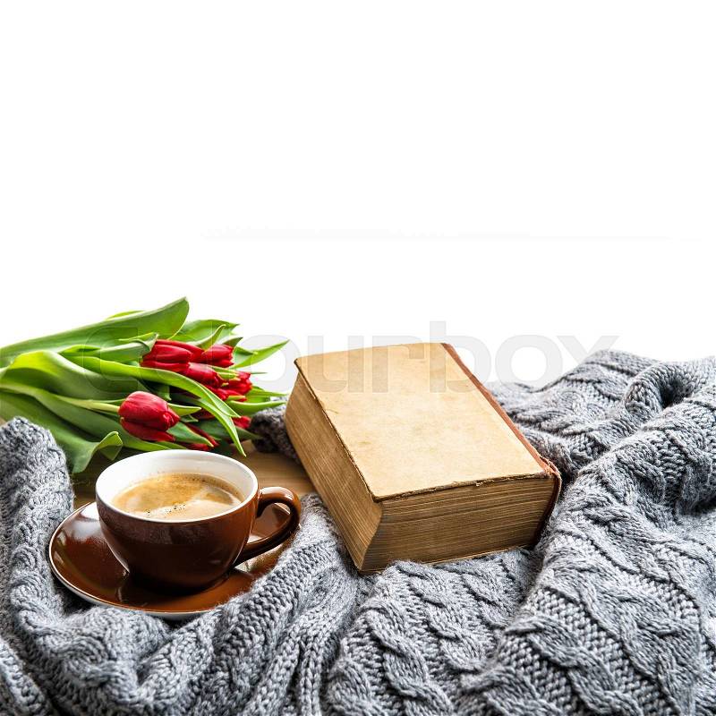 Cup of coffee, old book and tulip flowers. Coziness concept, stock photo