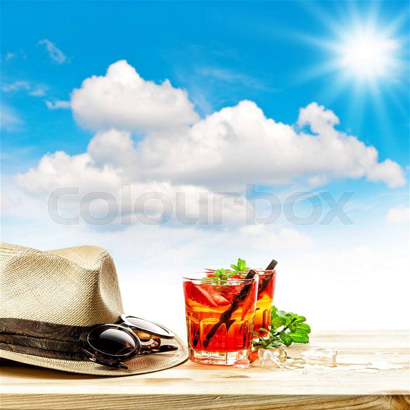 Red tropical drink and green mint leaves. Summer holidays concept sunny blue sky, stock photo