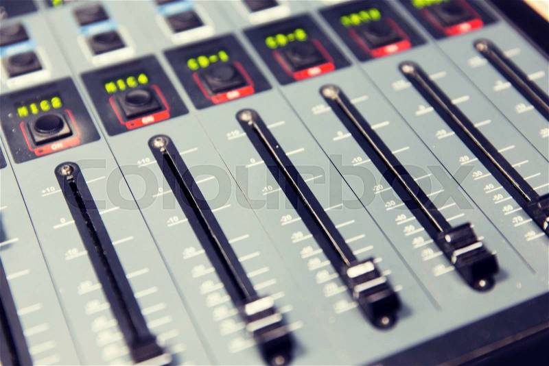 Technology, electronics and equipment concept - control panel at recording studio or radio station, stock photo