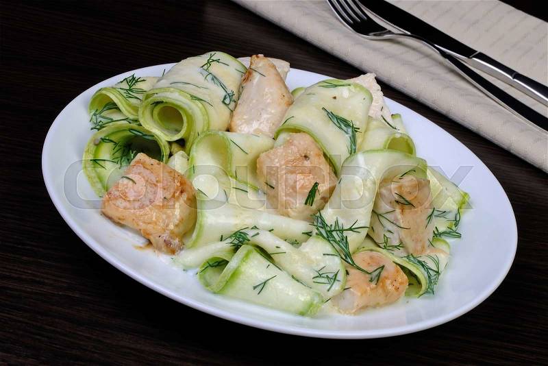 Zucchini salad with slices of chicken breast in milk sauce and dill, stock photo