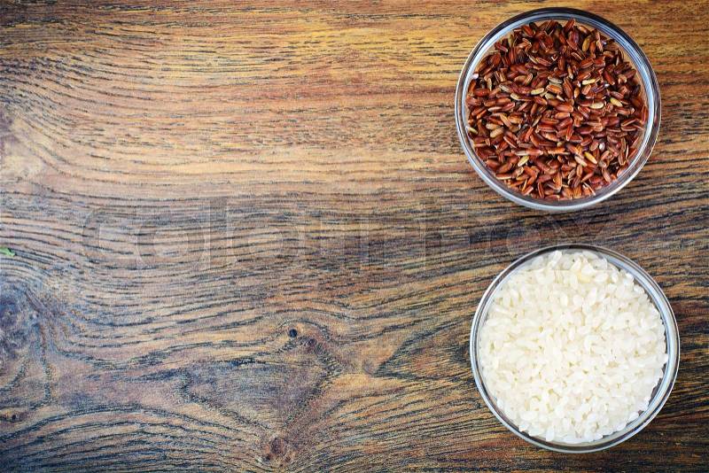 White and Red Rice in Glass Cup on Wooden Background Studio Photo, stock photo