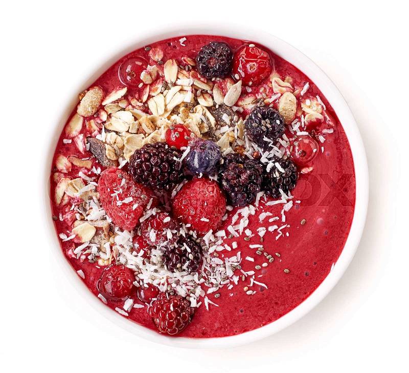 Breakfast smoothie bowl topped with frozen berries, top view, stock photo