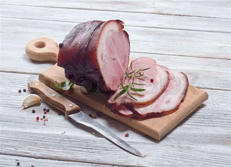 Smoked ham on wooden background, stock photo