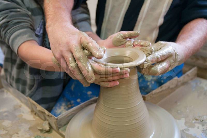 Potter teaches the student the art of clay pottery, stock photo