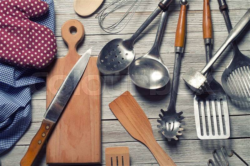 Various kitchen utensils on wooden table, stock photo