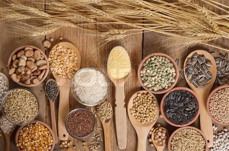 Cereal grains , seeds, beans on wooden background, stock photo