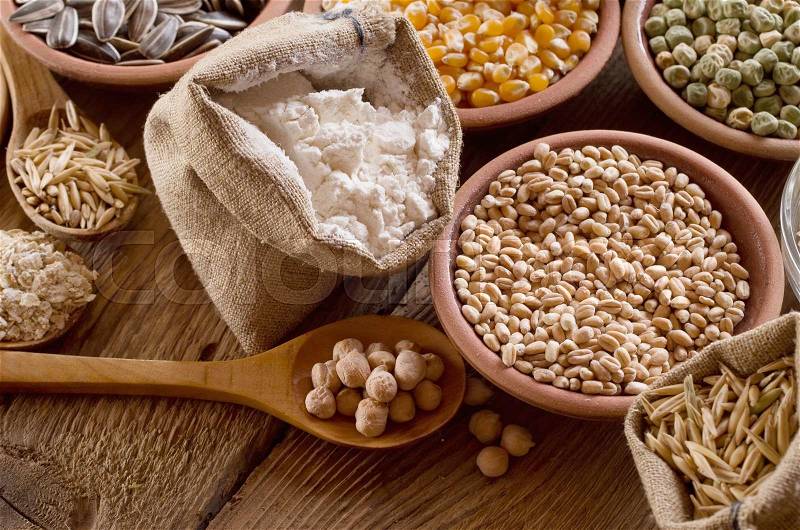 Cereal grains , seeds, beans on wooden background, stock photo