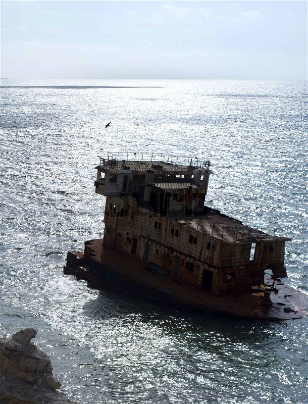 Rusty industrial ship near the coastline. Crimea, stock photo