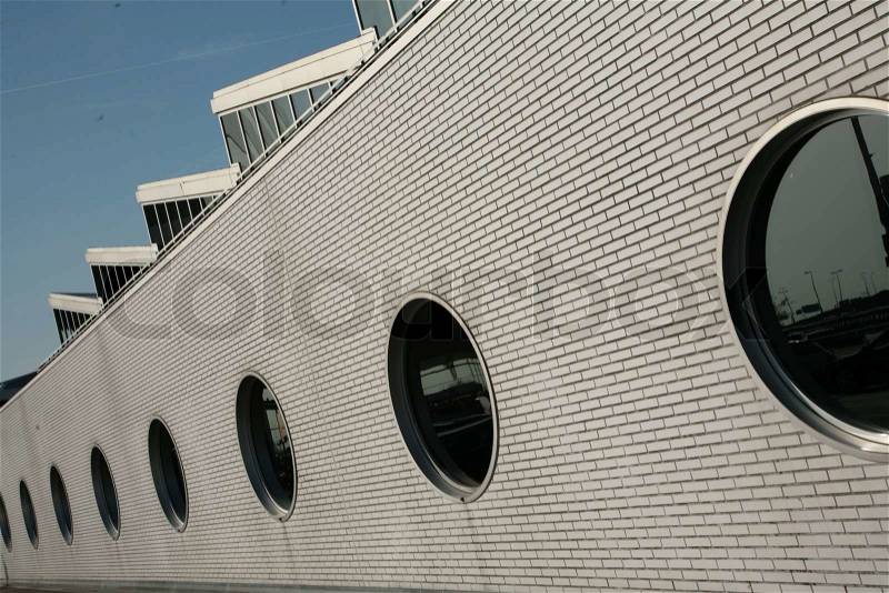 White wall with round window in the summer, stock photo