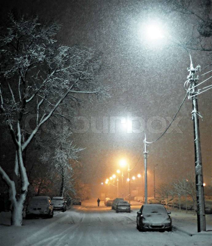 Snow covered cars on the night street, stock photo