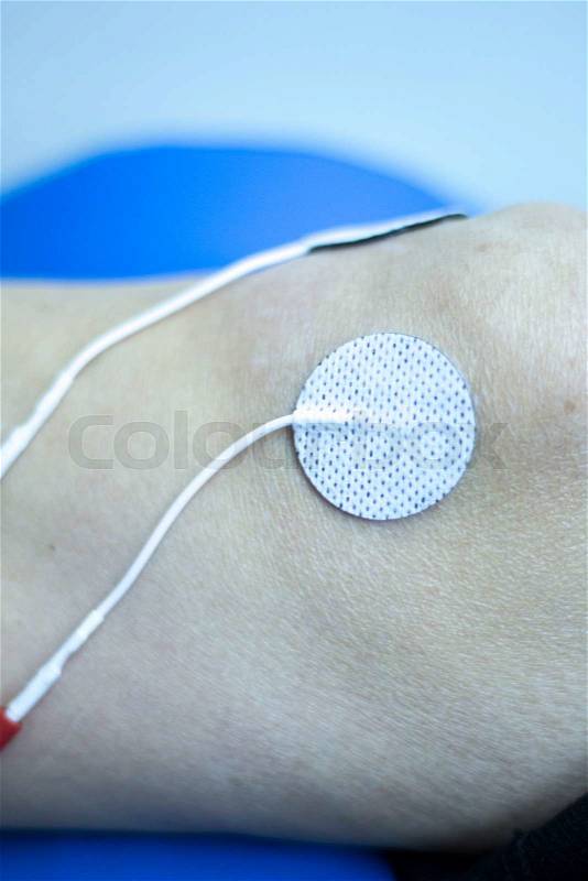 Physical therapy clinic of hospital. Patient having electrical impulse physiotherapy treatment for rehabilitation orthopedic medical care for muscle injury and ligament recovery, stock photo