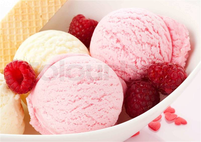 Scoops of Vanilla and Raspberry Ice Cream with fresh fruit, stock photo