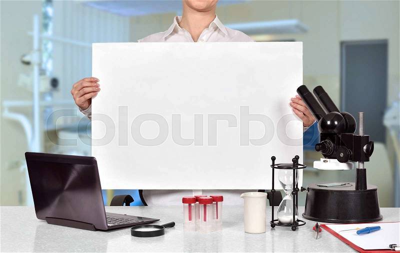 Female medical or scientific researcher holding blank placard, stock photo