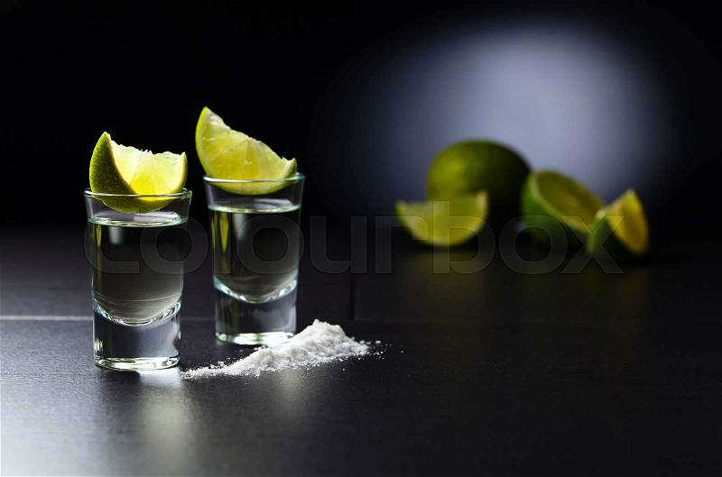 Tequila , lime and salt on black table, stock photo
