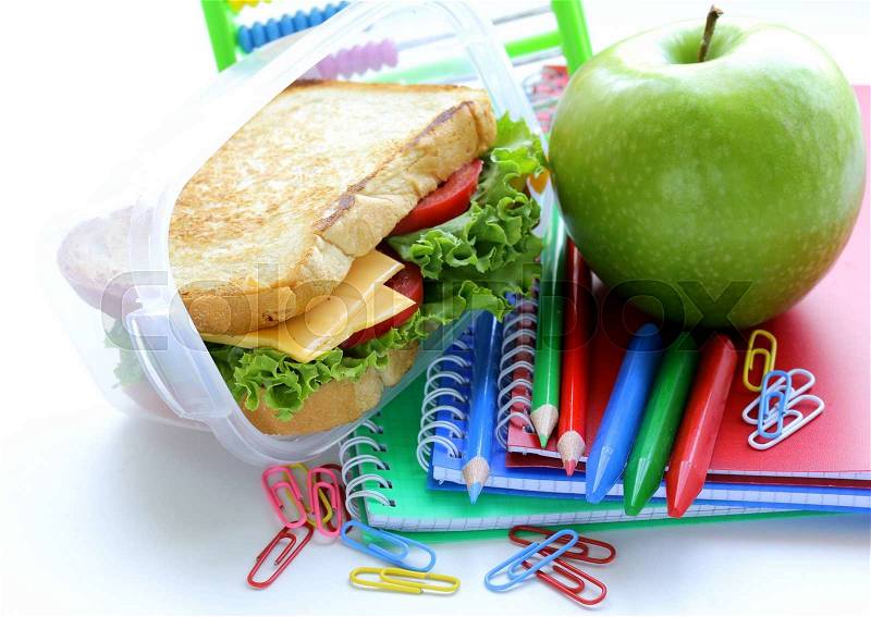 Sandwich with cheese and tomato and green apple for a healthy school lunch, stock photo