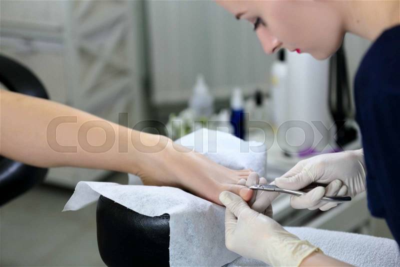 Responsible work pedicure masters in salon for a clients, stock photo