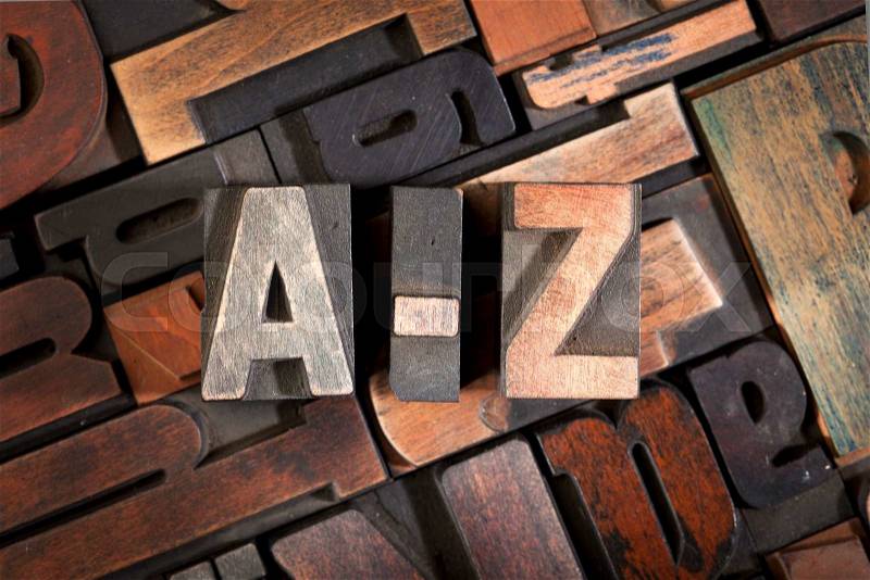 A-z written with vintage letterpress printing blocks on random letters background, stock photo