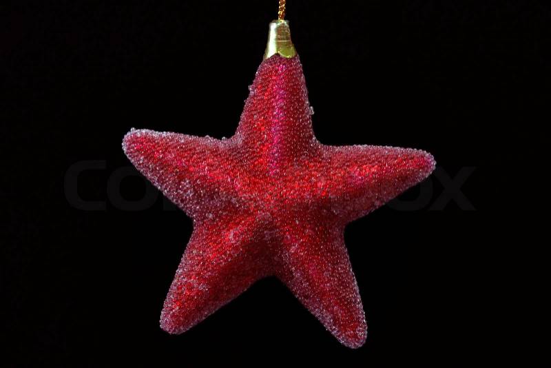 Decorative chrismas star isolated on black background, stock photo