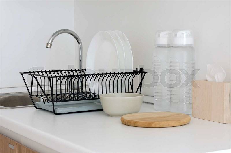 Utensil on white top counter sink in kitchen, stock photo