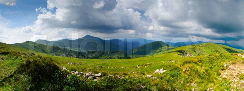 Beautiful blue sky and grass high up in Carpathian mountains, storm is coming. Goverla behind, stock photo