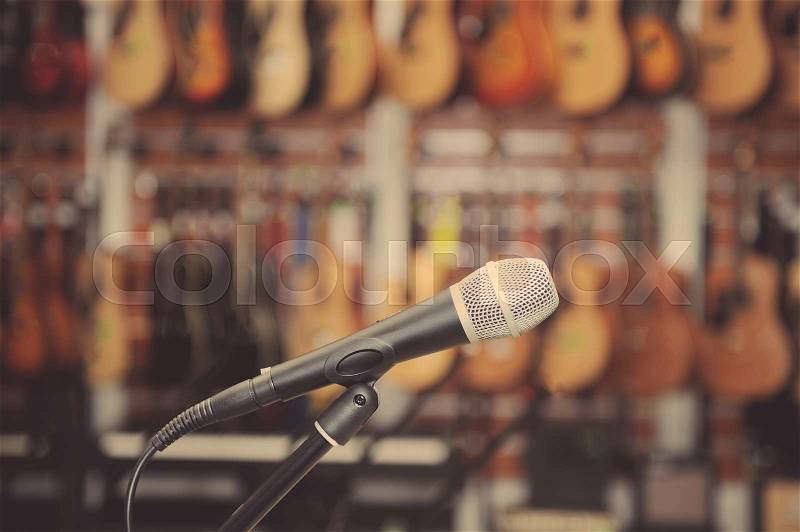Microphone against the background of music shop, stock photo
