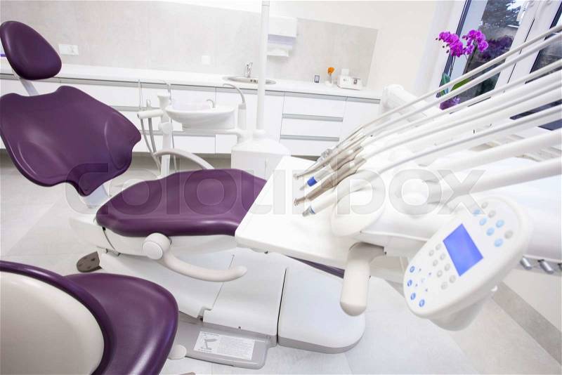 Modern dental practice. Dental chair and other accessories used by dentists, stock photo