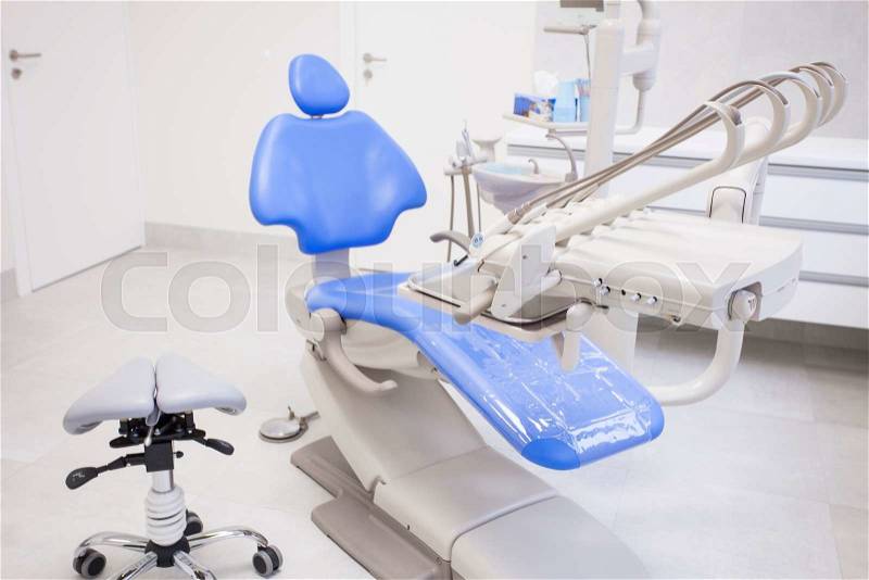 Modern dental practice. Dental chair and other accessories used by dentists, stock photo