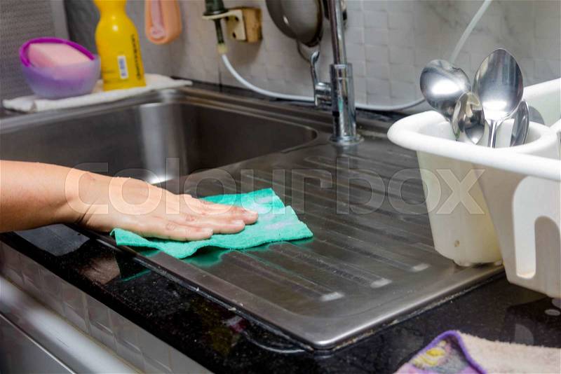 Women washing sink in kitchen room, stock photo