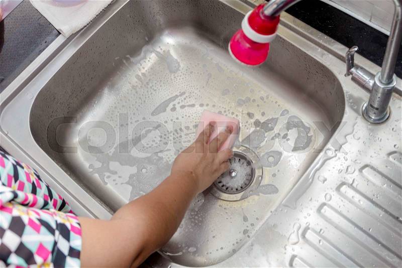 Women washing sink in kitchen room, stock photo