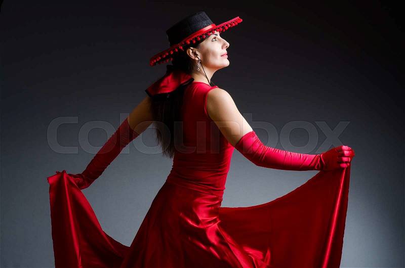 Woman dancing dances in red dress, stock photo