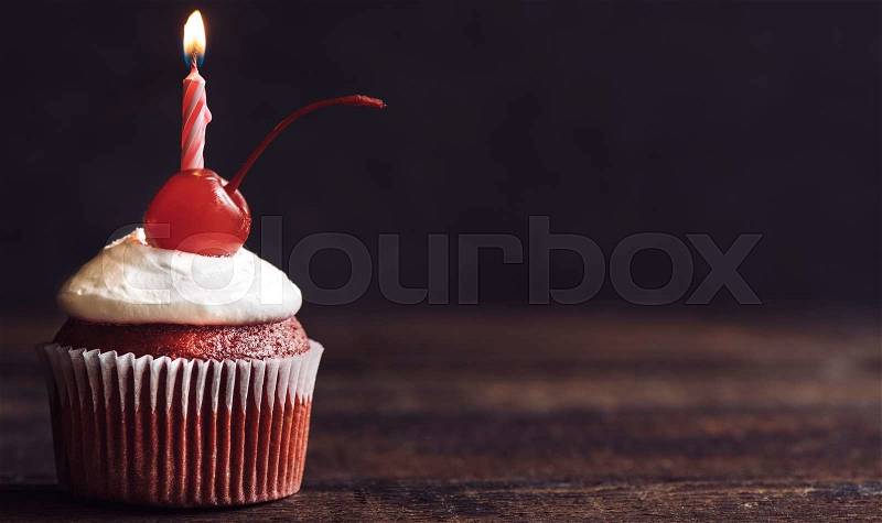 Birthday cupcake with candle on wooden background,selective focus and copy space , stock photo